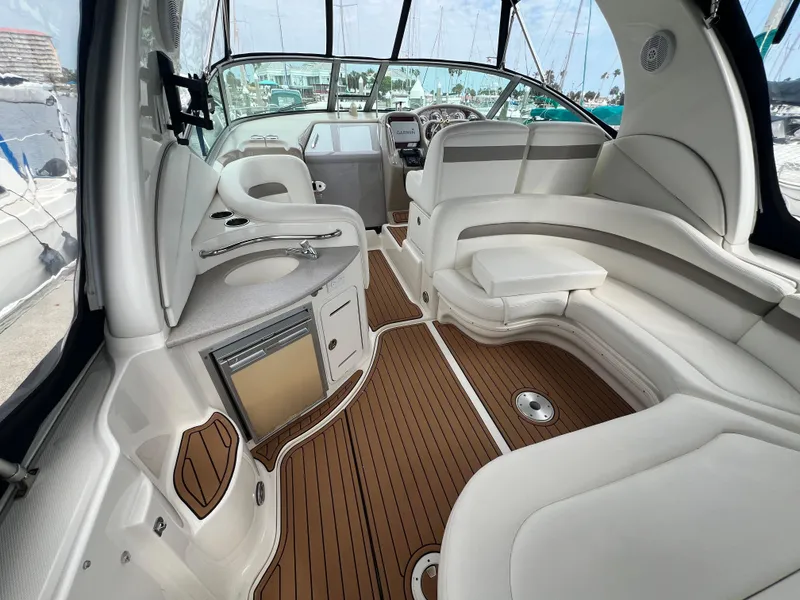 Slide: The Image of 2003 Sea Ray 320 Sundancer interior with white seating and wood flooring. - 37