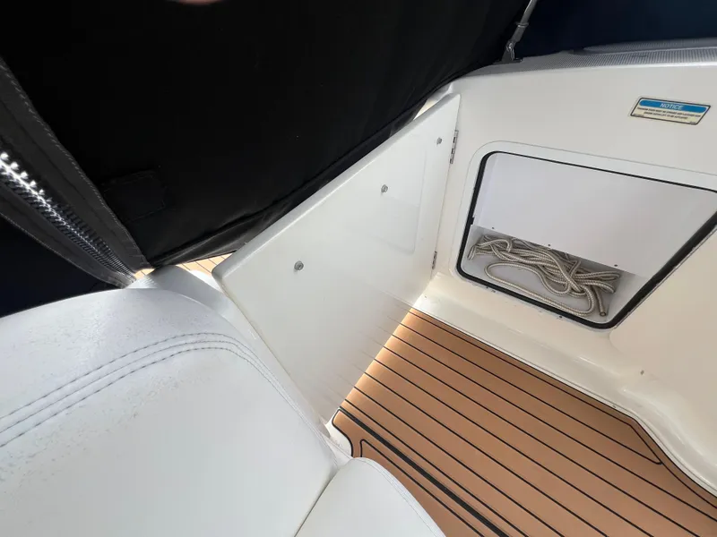 Slide: The Image of Interior view of 2003 Sea Ray 320 Sundancer with teak flooring and storage compartment. - 39
