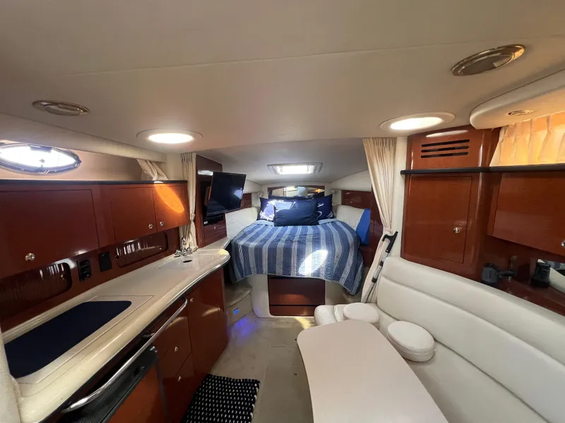 Slide: The Image of Interior of 2003 Sea Ray 320 Sundancer yacht with cozy cabin and modern amenities. - 49