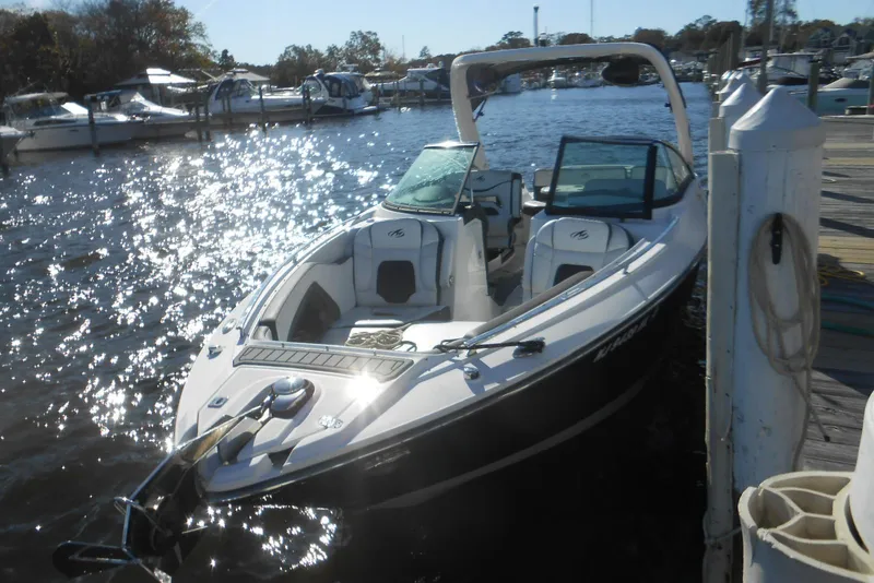 Slide: The Image of 2019 Monterey 298SS Super Sport boat docked in a sunny marina. - 2