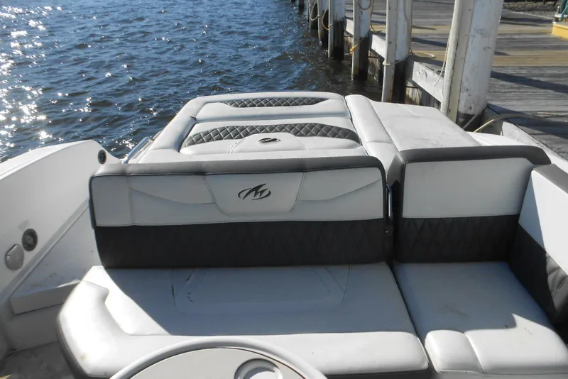 Slide: The Image of 2019 Monterey 298SS Super Sport boat interior with cushioned seating by the water. - 4