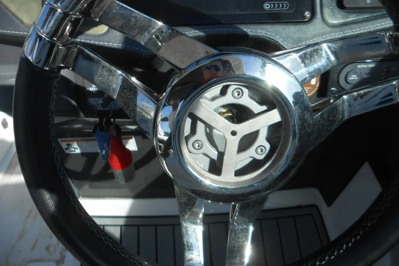 Slide: The Image of Steering wheel of 2019 Monterey 298SS Super Sport boat, featuring chrome accents. - 6