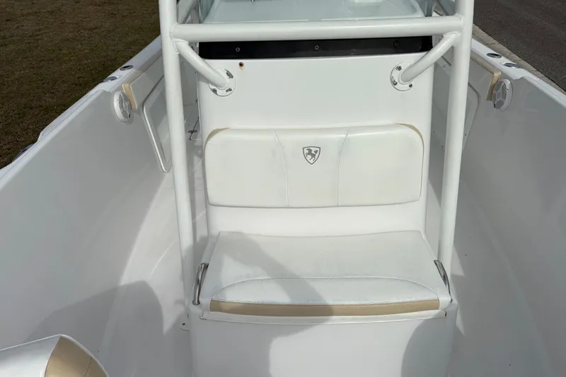 Slide: The Image of 2022 Century 2600 Center Console boat interior with white seating and speakers. - 16