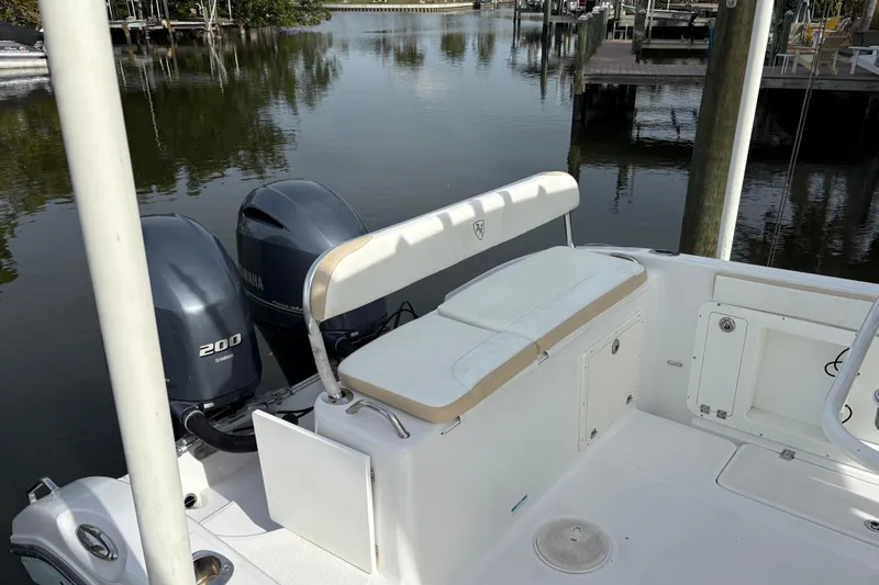 Slide: The Image of Century 2600 Center Console 2022 boat with Yamaha engines docked by calm waters. - 19