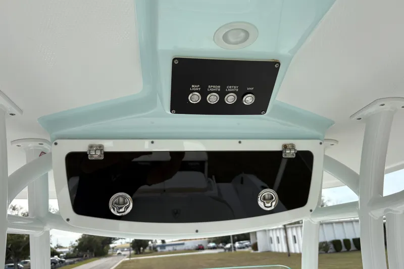 Slide: The Image of 2022 Century 2600 Center Console boat dashboard with control panel and storage compartment. - 21