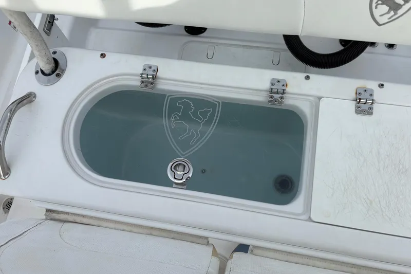 Slide: The Image of Livewell on 2022 Century 2600 Center Console boat, featuring a transparent lid and secure latches. - 24