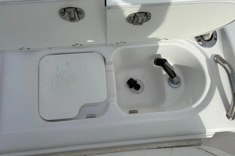 Slide: The Image of 2022 Century 2600 Center Console boat sink with faucet and storage compartment. - 25