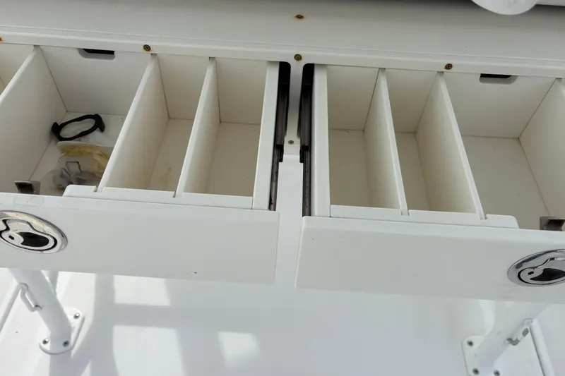 Slide: The Image of Open storage compartments on a 2022 Century 2600 Center Console boat. - 26