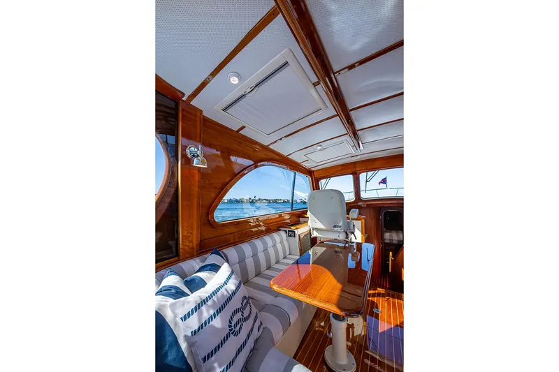 Slide: The Image of Luxurious interior of 2008 Hinckley Talaria 44 MY yacht with polished wood and striped seating. - 16
