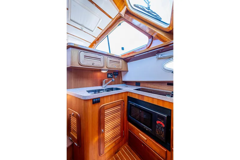 Slide: The Image of 2008 Hinckley Talaria 44 MY yacht kitchen with wood cabinetry and modern appliances. - 21