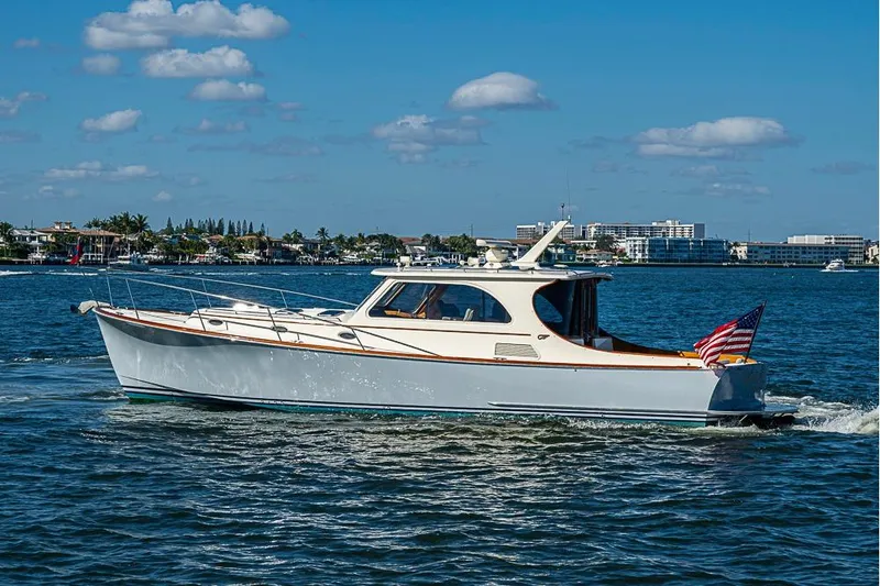 Slide: The Image of 2008 Hinckley Talaria 44 MY cruising on a sunny day with cityscape background. - 3