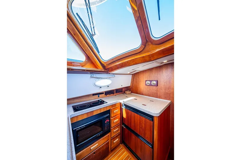 Slide: The Image of Luxurious 2008 Hinckley Talaria 44 MY yacht kitchen with skylight and modern appliances. - 22