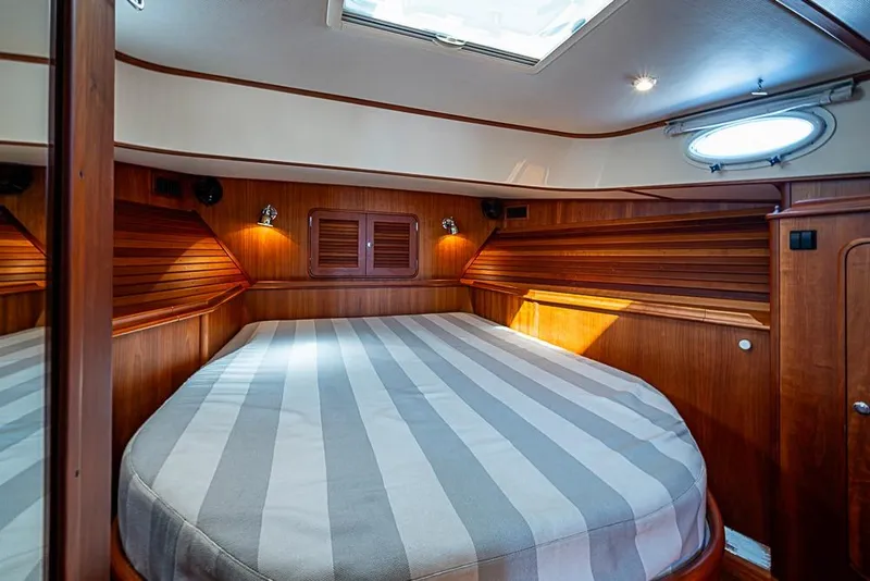 Slide: The Image of Luxurious cabin interior of 2008 Hinckley Talaria 44 MY yacht with striped bedding. - 23