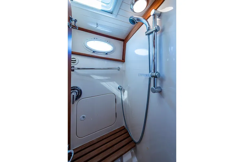 Slide: The Image of Shower area in 2008 Hinckley Talaria 44 MY yacht with wooden accents and porthole. - 27