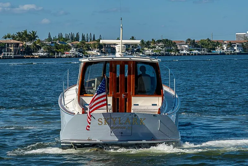 Slide: The Image of 2008 Hinckley Talaria 44 MY yacht cruising on a sunny day, displaying an American flag. - 4