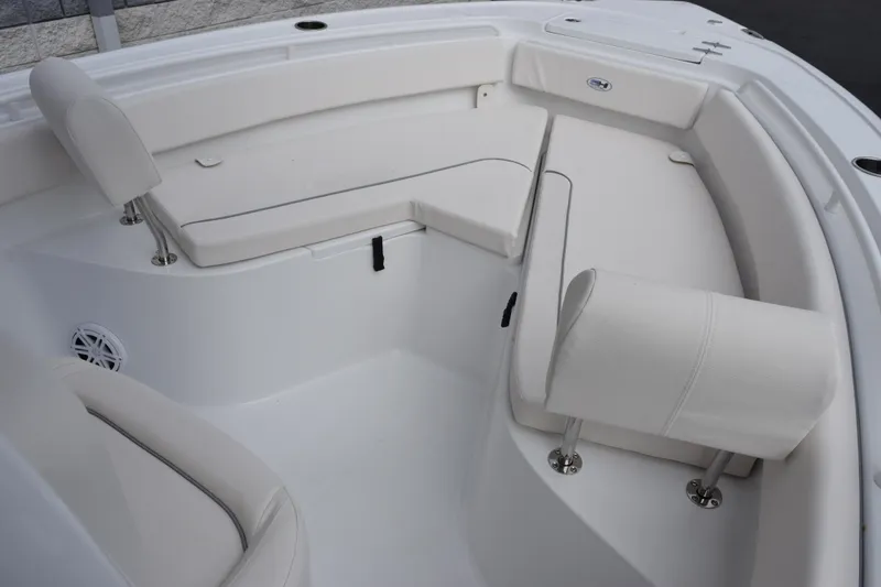 Slide: The Image of 2026 Sea Hunt Ultra 245 SE boat interior with white cushioned seating. - 12