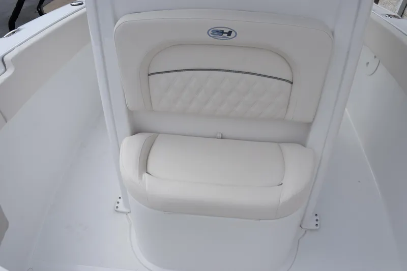 Slide: The Image of 2026 Sea Hunt Ultra 245 SE boat interior with white cushioned seating. - 13
