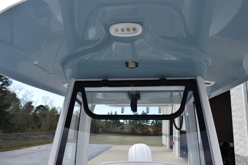 Slide: The Image of 2026 Sea Hunt Ultra 245 SE boat interior with overhead console and windshield. - 14