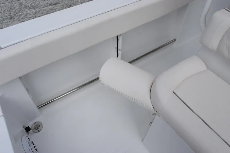 Slide: The Image of 2026 Sea Hunt Ultra 245 SE boat interior with white seating and stainless steel accents. - 17