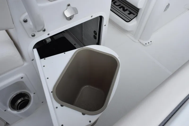 Slide: The Image of Storage compartment with trash bin on 2026 Sea Hunt Ultra 245 SE boat. - 18