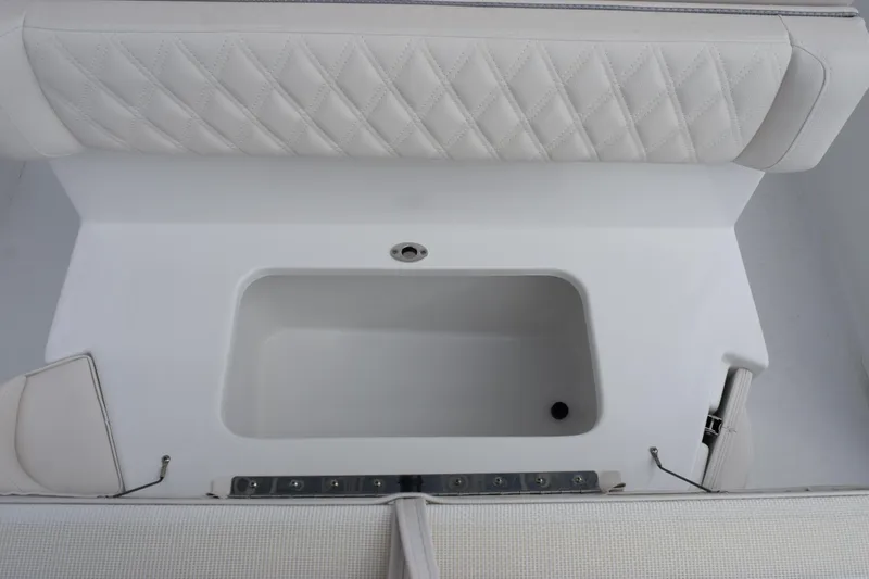 Slide: The Image of Interior view of 2026 Sea Hunt Ultra 245 SE boat with white seating and storage compartment. - 21