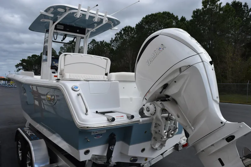 Slide: The Image of 2026 Sea Hunt Ultra 245 SE boat with Yamaha outboard motor, parked outdoors. - 6