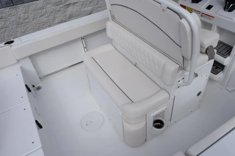 Slide: The Image of 2026 Sea Hunt Ultra 245 SE boat interior with white cushioned seating. - 8