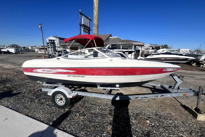 The Image of 2007 Stingray 185 LS/LX boat with red and white design on a trailer. - 0