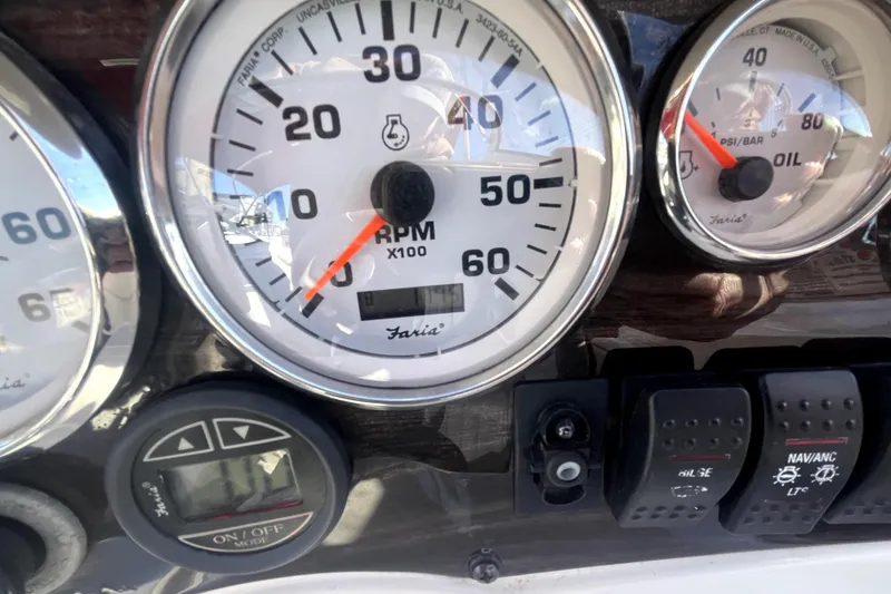 Slide: The Image of 2007 Stingray 185 LS/LX boat with white and red interior, docked on a sunny day. - 14