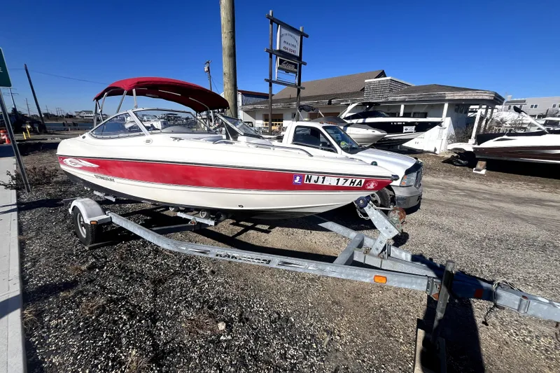 Slide: The Image of 2007 Stingray 185 LS/LX boat interior with red canopy and white seating. - 4