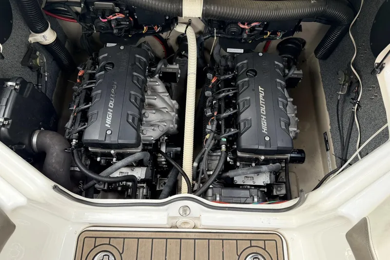 Slide: The Image of Engine compartment of a 2014 Yamaha Boats 242 Limited S, featuring dual high-output engines. - 2