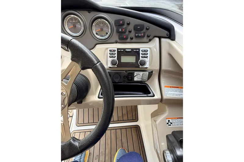 Slide: The Image of 2014 Yamaha Boats 242 Limited S dashboard with steering wheel and control panel. - 7