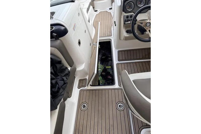 Slide: The Image of 2014 Yamaha Boats 242 Limited S interior with open storage compartment. - 8