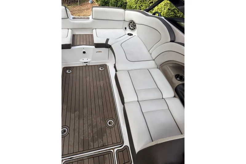 Slide: The Image of 2014 Yamaha Boats 242 Limited S interior with white seating and wood-style flooring. - 9