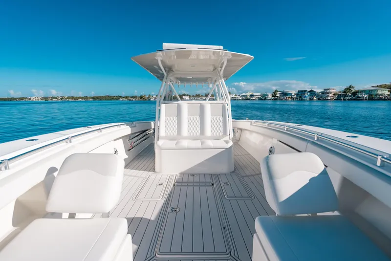 Slide: The Image of 2016 Invincible 42 Open Fisherman boat on calm blue water, clear sky background. - 17