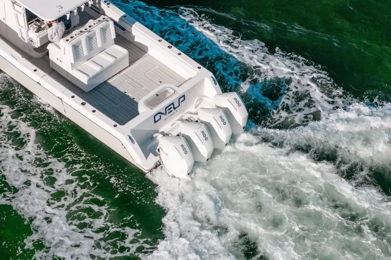 Slide: The Image of 2016 Invincible 42 Open Fisherman boat with triple outboard engines on green water. - 18