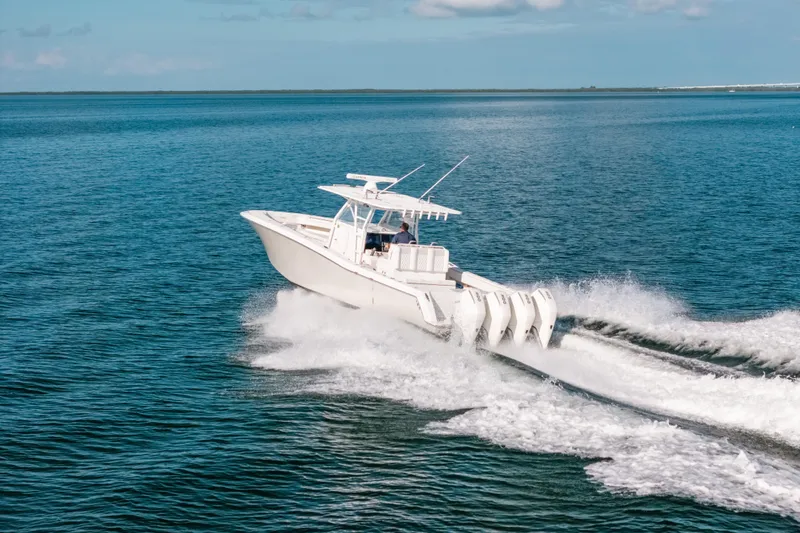 Slide: The Image of 2016 Invincible 42 Open Fisherman speeding on open water, showcasing powerful engines. - 2