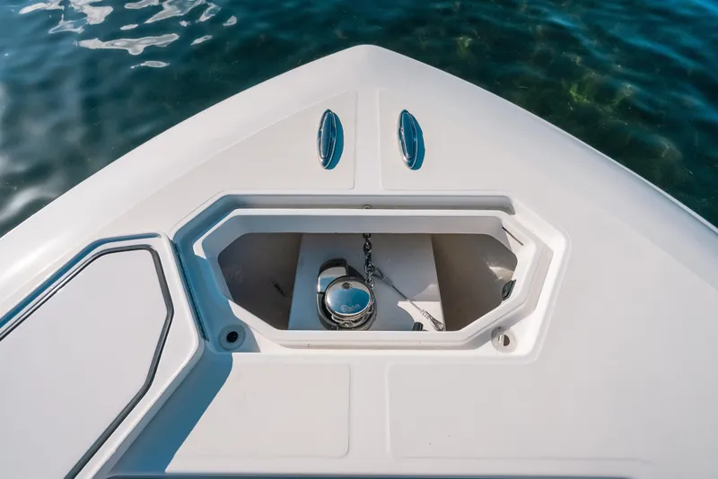 Slide: The Image of Bow of 2016 Invincible 42 Open Fisherman with anchor compartment, on clear water. - 21