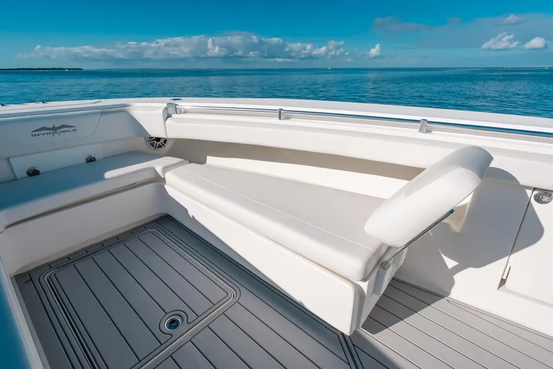 Slide: The Image of 2016 Invincible 42 Open Fisherman boat interior with cushioned seating and ocean view. - 22