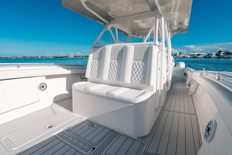 Slide: The Image of 2016 Invincible 42 Open Fisherman boat interior with white seating and ocean view. - 24