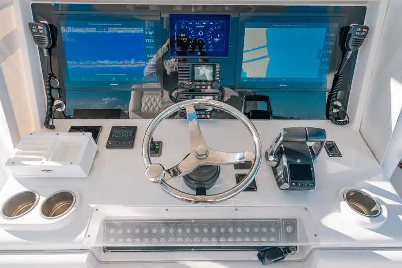 Slide: The Image of Helm of 2016 Invincible 42 Open Fisherman with advanced navigation displays and controls. - 27