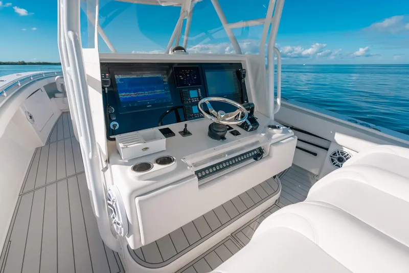 Slide: The Image of 2016 Invincible 42 Open Fisherman boat cockpit with modern navigation equipment and ocean view. - 28