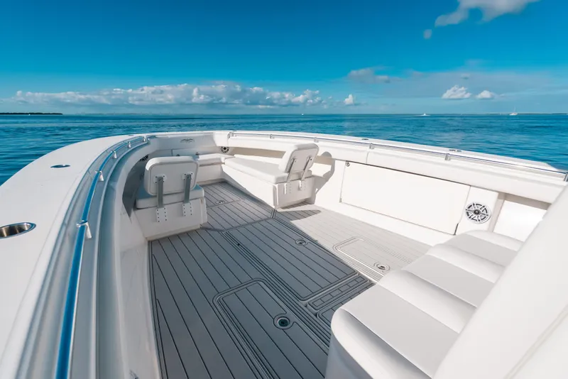 Slide: The Image of 2016 Invincible 42 Open Fisherman boat interior with seating, on calm ocean waters. - 30