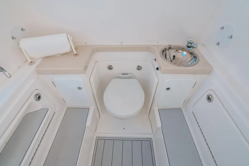 Slide: The Image of 2016 Invincible 42 Open Fisherman boat bathroom with toilet and sink. - 35
