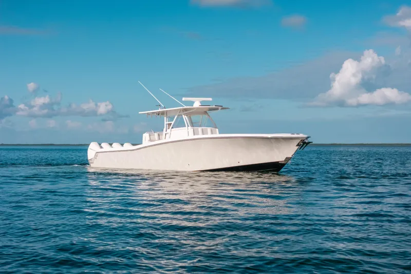 Slide: The Image of 2016 Invincible 42 Open Fisherman boat on calm ocean under blue sky. - 4