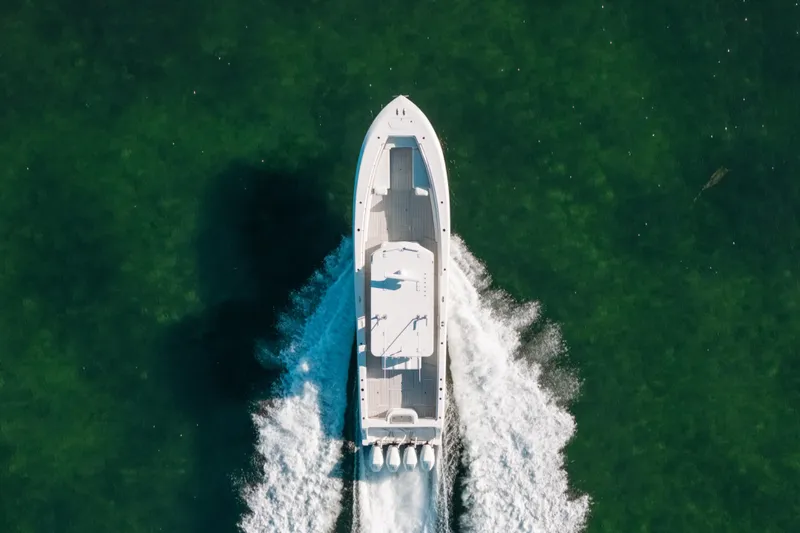 Slide: The Image of Aerial view of 2016 Invincible 42 Open Fisherman boat cruising on green water. - 5