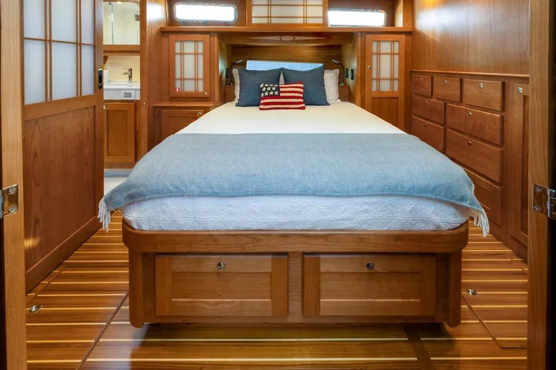 Slide: The Image of Luxurious 2027 Sabre 51 Salon Express cabin with elegant wood finish and cozy bedding. - 5