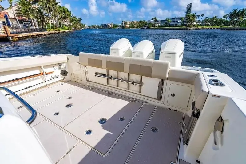 Slide: The Image of 2022 Boston Whaler 420 Outrage boat deck with scenic waterfront view. - 17