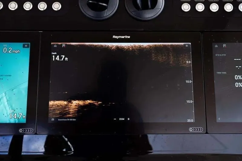 Slide: The Image of Boston Whaler 420 Outrage 2022 dashboard with Raymarine navigation displays. - 31