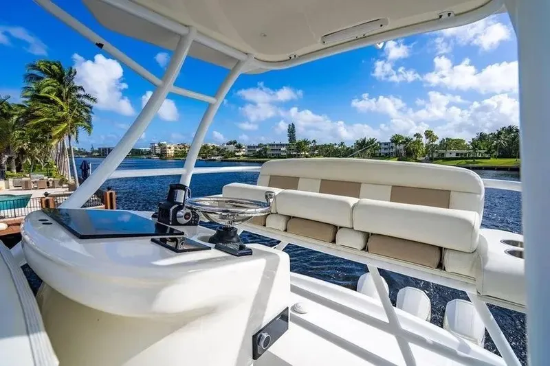 Slide: The Image of 2022 Boston Whaler 420 Outrage boat interior with seating, ocean view, and clear blue sky. - 39